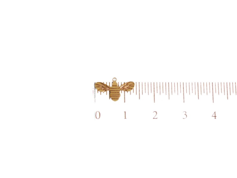 May include: A gold-colored bee charm with a striped pattern. The charm is about 1 inch long and is shown next to a ruler.