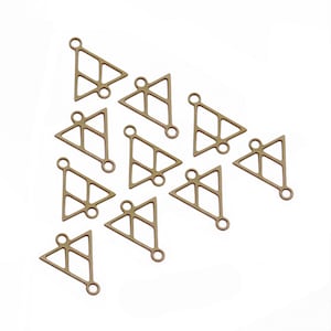 May include: A group of 12 gold-toned metal triangle charms with a geometric design. Each charm has a small loop at the top for attaching to jewelry or other crafts.
