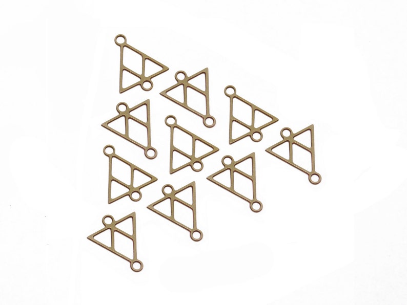 May include: A group of 12 gold-toned metal triangle charms with a geometric design. Each charm has a small loop at the top for attaching to jewelry or other crafts.
