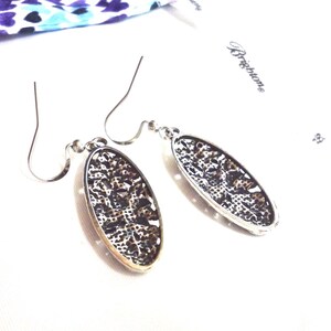 The backs of the earrings show a crosshatch textured design.