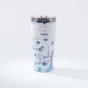 May include: Stainless steel tumbler with a blue and white oyster shell design. The tumbler has a black lid and a white label that reads "Kim Hovell Stainless Steel Tumbler". The tumbler holds 20oz.