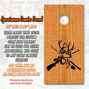 May include: A black and white vinyl decal of a deer head with crossed rifles and a fish. The decal is 18 inches tall and 20 inches wide. The decal is for custom corn hole boards and can be used for other applications. The decal has no background colour and is ready to apply.
