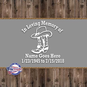 May include: A white silhouette of a cowboy boot and hat on a gray background with the text "In Loving Memory of" above the boot and hat and the text "Name Goes Here 1/23/1945 to 7/15/2018" below the boot and hat.