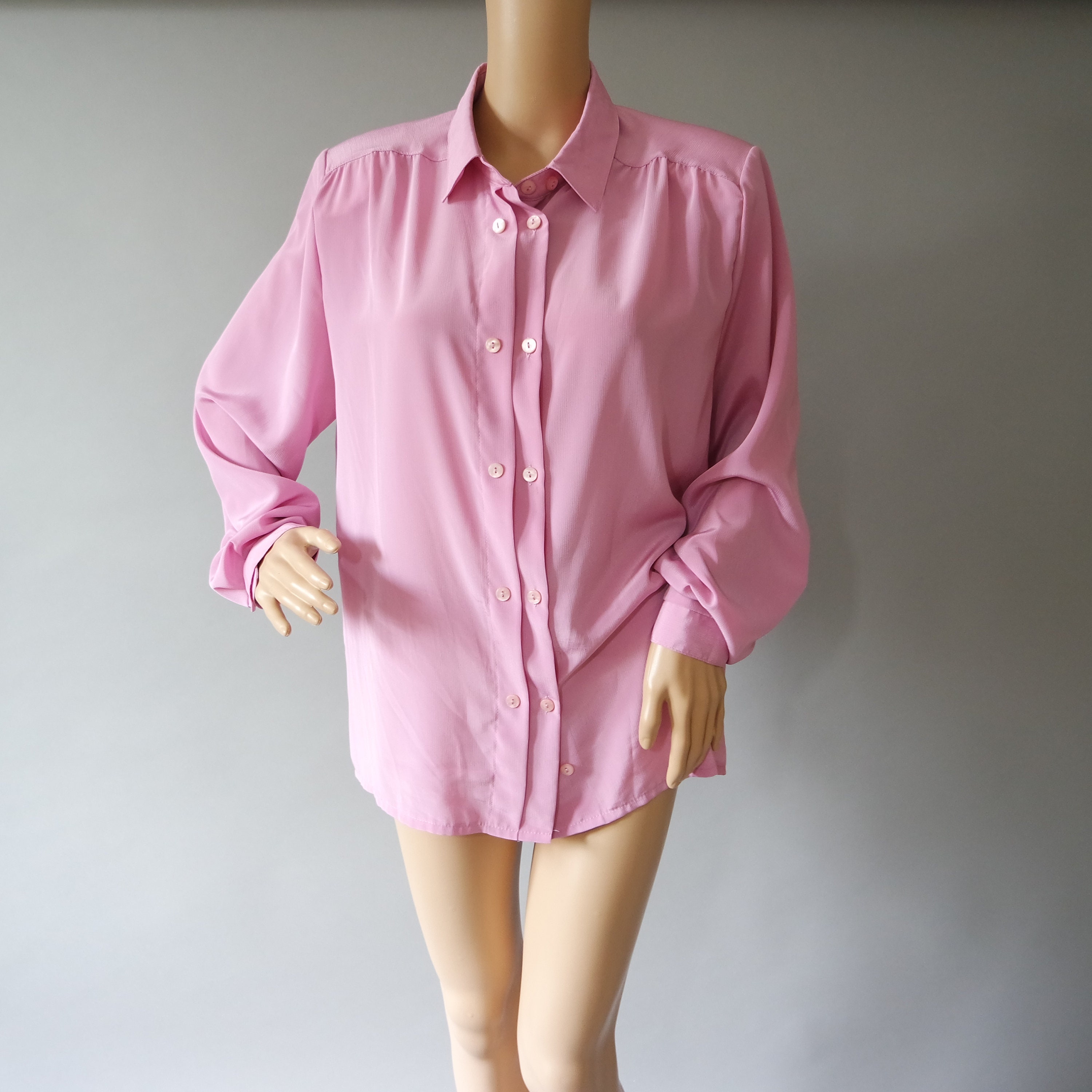 light pink shirt with navy blue pants