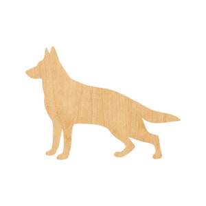 May include: A wooden cutout of a German Shepherd dog in a standing position. The cutout is made of light brown wood with a natural wood grain pattern.