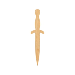 May include: A wooden cutout of a dagger with a rounded handle and a pointed tip.