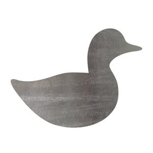 May include: A flat, two-dimensional cutout in the shape of a duck. The object features a solid, dark gray color with a visible, subtle wood grain texture throughout its entire surface, showing a simple silhouette of a duck facing to the right.