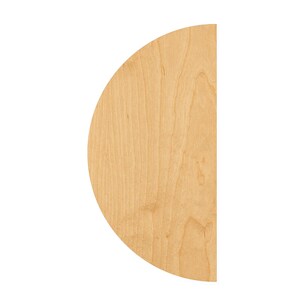 May include: A semi-circular wooden cutout featuring a light tan color with a visible natural wood grain pattern. The object has a flat vertical edge on the right side and a smooth curved edge on the left side, showcasing a clean, unfinished surface.