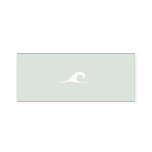 May include: A rectangular light sage green mat featuring a centered white graphic of a stylized ocean wave. The mat has rounded corners and a smooth, flat surface, providing a clean and simple aesthetic for various functional uses in a home.