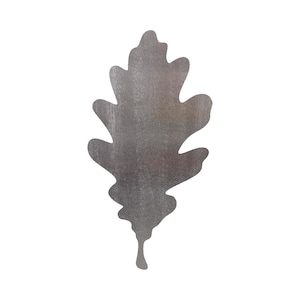 May include: A silver metal oak leaf cutout. The leaf is a simple silhouette with a textured surface.