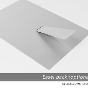May include: The back of a metal print with an easel stand. The stand is made of metal and folds down flat.