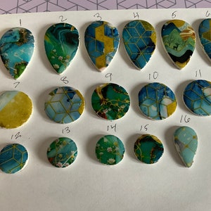 May include: Assortment of 16 ceramic tiles with various geometric and floral patterns in shades of blue, green, and gold. The tiles are numbered 1 through 16.