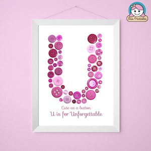 May include: A framed print with a pink letter U made of buttons. The text below reads "Cute as a button U is for Unforgettable".