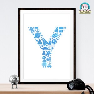 May include: A printable wall art design featuring the letter Y made up of blue silhouette icons of toys, such as a rocket, a dinosaur, a sailboat, a teddy bear, a soccer ball, a train, a car, a robot, and a music note. The design is on a white background and is framed in a black frame.