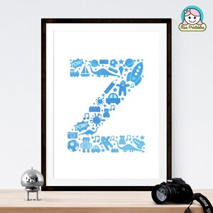 May include: A printable wall art design featuring the letter Z made up of blue and white illustrations of toys, stars, and other kid-friendly icons. The design is framed in a black frame.