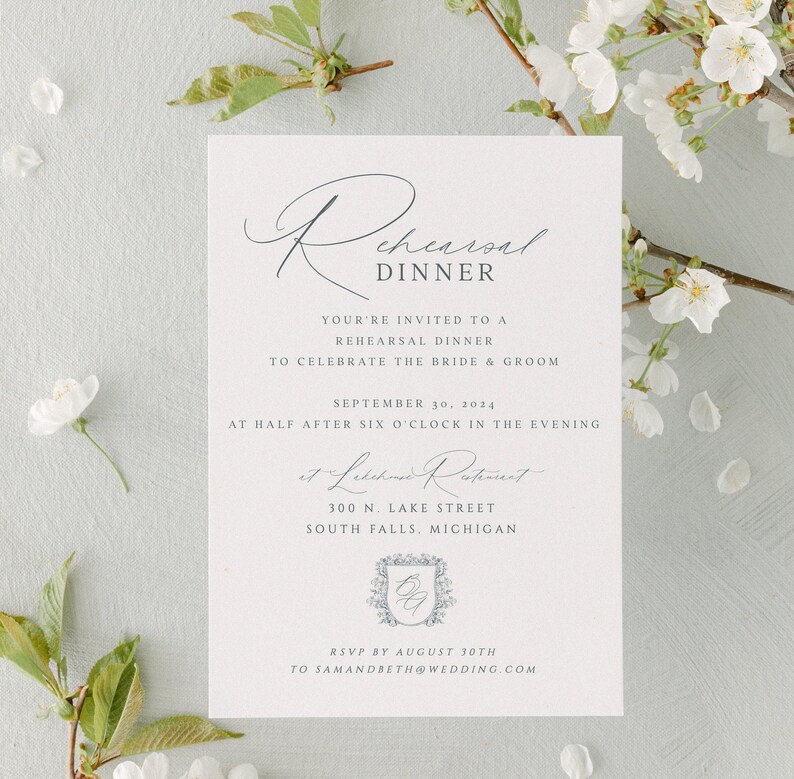 May include: A white invitation card with a gray script font announcing a rehearsal dinner for a wedding. The invitation includes the date, time, location, and RSVP information. The text reads "Rehearsal Dinner", "You're invited to a rehearsal dinner to celebrate the bride & groom", "September 30, 2024", "at Half after six o'clock in the evening", "at Lakeside Restaurant", "300 N. Lake Street", "South Falls, Michigan", "RSVP by August 30th to samandbeth@wedding.com".