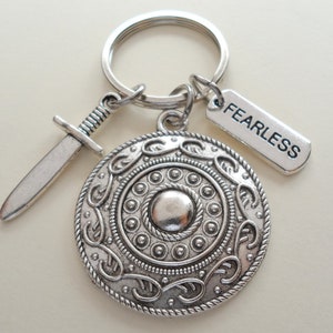 May include: Silver keychain with a shield, sword, and a tag that says "FEARLESS".