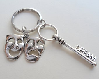 May include: Silver key chain with a silver key charm that says "DREAM" and a charm with two silver theatrical masks, one smiling and one frowning.