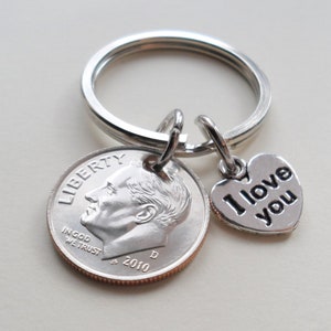 May include: Silver keychain with a dime and a heart charm that says "I love you".