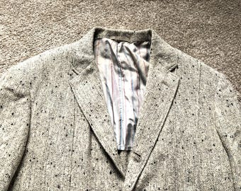 May include: A beige blazer with a speckled pattern. The blazer has a single button closure and a lined interior.