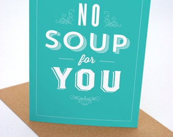 Op de afbeelding: Een turquoise kaart met witte tekst die "NO SOUP for YOU" luidt in een vintage lettertype. De kaart heeft een decoratieve rand.