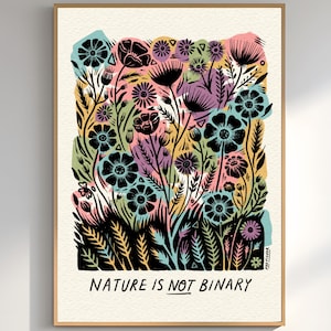 May include: A framed art print featuring a colorful floral design with the text "NATURE IS NOT BINARY." The artwork showcases a variety of flowers in shades of black, pink, blue, yellow, and purple. The print is mounted in a wooden frame.