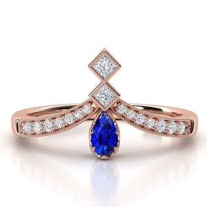 Sapphire and diamond engagement ring. Diamond ring. Pear shape sapphire and princess diamond.
