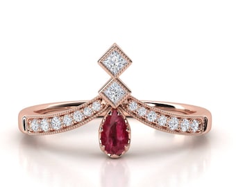 Ruby and diamond engagement ring. Diamond ring. Pear shape sapphire and princess diamond.