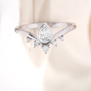 Diamond ring. Engagement ring. Pear shape modern designer engagement ring. Available in Platinum and 14K or 18K.