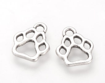 May include: Two silver-toned metal paw print charms with a loop at the top for attaching to jewellery or other crafts.