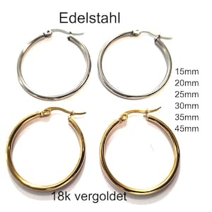 Könnte beinhalten: Zwei Paar Creolen, ein silberfarbenes und ein goldfarbenes Paar, mit dem Text Edelstahl und 18k vergoldet. Rechts neben den silberfarbenen Creolen ist eine Liste der Größen 15mm, 20mm, 25mm, 30mm, 35mm und 45mm abgebildet.