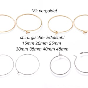 Könnte beinhalten: Eine Auswahl an gold- und silberfarbenen Creolen in verschiedenen Größen. Die Ohrringe sind aus chirurgischem Edelstahl gefertigt und in Größen von 15 mm bis 45 mm erhältlich.