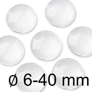 Könnte beinhalten: Sechs klare Glascabochons, jeder mit einem Durchmesser von 6-40 mm.