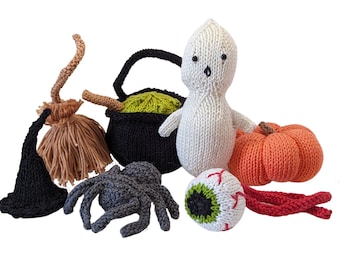 May include: A set of knitted Halloween decorations, including a ghost, a pumpkin, a cauldron, a spider, a witch's hat, and a googly eye.