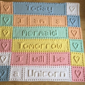 May include: A colorful crocheted baby blanket with the text "Today I am a mermaid tomorrow I will be a unicorn".