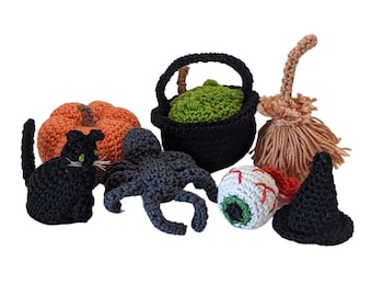 May include: A set of crocheted Halloween decorations including a black cat, a spider, a pumpkin, a cauldron, a witch's broom, a witch's hat, and a googly eye.