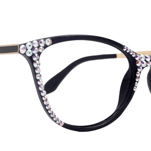May include: Black cat-eye glasses with rhinestones around the frame.