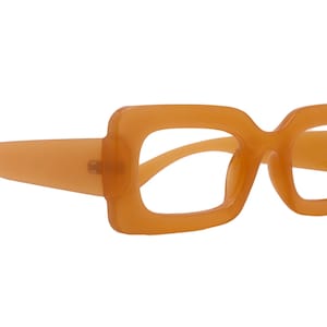 Puede incluir: Gafas tintadas de color naranja con montura cuadrada. Las gafas tienen una montura y patillas gruesas y sólidas. Las lentes son transparentes. El diseño general es retro y elegante.