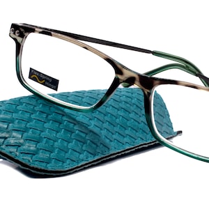 May include: Tortoise shell reading glasses with green frames and a blue case. The glasses have a +1.75 magnification and say "Flex-Spring Hinge" on the lens.