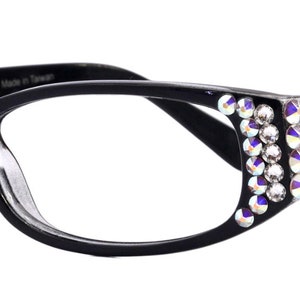 May include: Black plastic framed glasses with clear lenses and rhinestones on the sides.