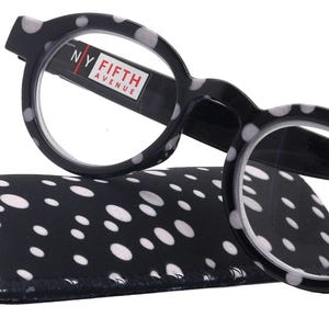 May include: Black and white polka dot reading glasses with a black case. The glasses have a "NY Fifth Avenue" logo on the side. The case is also black and white polka dot. The glasses have a +3.50 magnification.