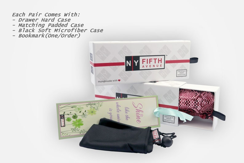 May include: White boxes with the text "NY FIFTH AVENUE" and red accents. The boxes contain a drawer hard case, a matching padded case, a black microfiber case, and a bookmark. The text "Each Pair Comes With:" is visible.