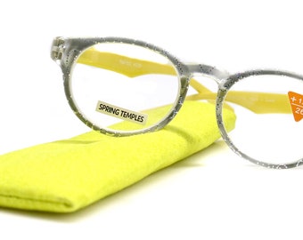 May include: Clear reading glasses with a yellow frame and spring temples. The glasses have a +1.50 lens and are 26 mm in size. The glasses are in a yellow microfiber pouch.