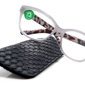 May include: Gray reading glasses with a tortoiseshell pattern on the arms and a black woven case. The glasses have a +4.00 magnification.