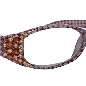 May include: Brown and grey patterned eyeglasses with clear lenses and a row of brown rhinestones on the side.