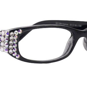 May include: Black plastic framed glasses with clear lenses and rhinestones on the sides.