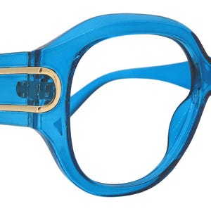 May include: Vibrant blue eyeglasses with a striking, large frame. The frames have a rounded design and feature gold-coloured accents on the temples. The lenses are clear, and the overall design is contemporary and stylish.