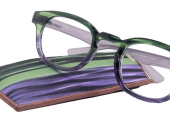 May include: Green and purple eyeglasses with a matching case. The glasses have a gradient effect, transitioning from green to purple. The case features a similar pattern. The glasses are resting on top of the case.