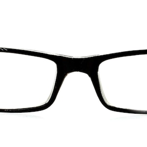May include: Black rectangular eyeglasses with clear lenses. The frames are adorned with sparkling, iridescent rhinestones along the outer edges. The temples are black and curve gently. The glasses are set against a white background.