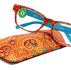 May include: A pair of orange and blue reading glasses with a paisley print design. The glasses are in a matching paisley print case. The glasses have a +2.25 strength and are made in Taiwan.